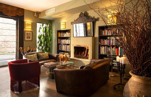a living room with couches and bookshelves at Hotel Ibrahim Pasha in Istanbul
