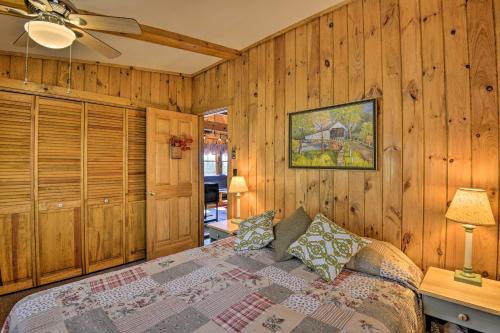 a bedroom with a bed and a ceiling fan at Springwater Cabin Near Hiking, Lakes, and Vineyards in Springwater