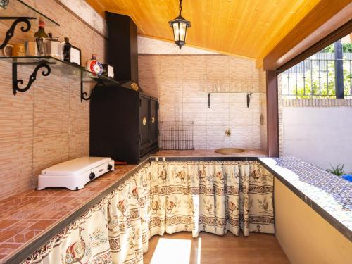 a kitchen with a counter top with a window at Casa jofrais in La Zubia
