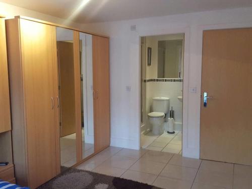 a room with a bathroom with a toilet and a door at Hidden Gem in Manchester