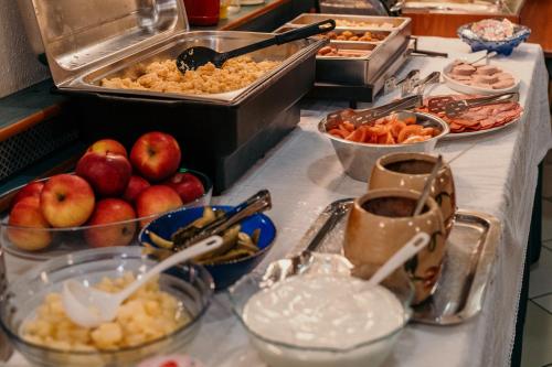 a buffet line with many different types of food at Tisza Sport Hotel in Szeged