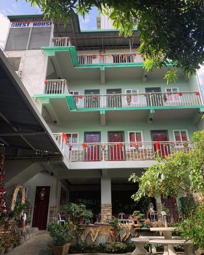 a building with balconies on the side of it at First Baby Bytes Guest House in Siquijor