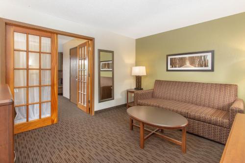 a living room with a couch and a table at AmericInn by Wyndham Calumet in Calumet
