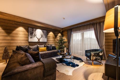 a living room with a couch and a chair at Manali Lodge by Alpine Resorts in Courchevel