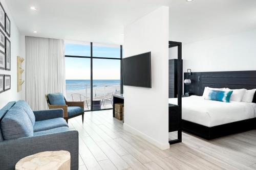 a hotel room with a bed and a living room at Wave Resort in Long Branch