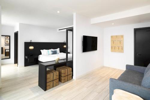 a bedroom with a bed and a living room with a couch at Wave Resort in Long Branch