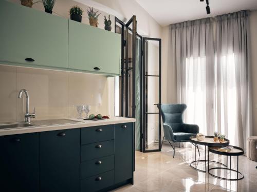 a kitchen with a sink and a table and a chair at Bella Vista Building A - 100m from Solomos Square, by ZanteWize in Zakynthos Town