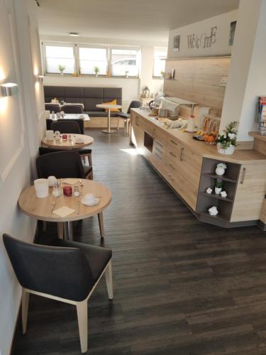 a restaurant with tables and chairs and a counter at Hotel Novostar in Kassel