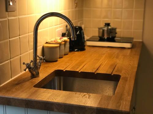 a kitchen counter with a sink in a kitchen at Brinsley Barn in Blagdon