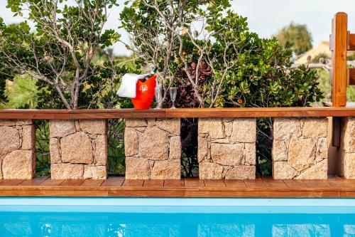 a retaining wall next to a swimming pool at Costa Paradiso Resort in Costa Paradiso