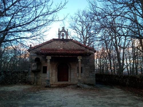 a small building with a tower on top of it at Hostal La Balsá in La Alberca