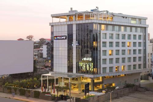 a building with a sign on the side of it at Ramada Encore Domlur Bangalore in Bengaluru