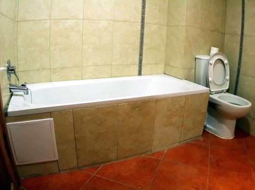a bathroom with a bath tub and a toilet at Planet Oasis Resort Dahab in Dahab