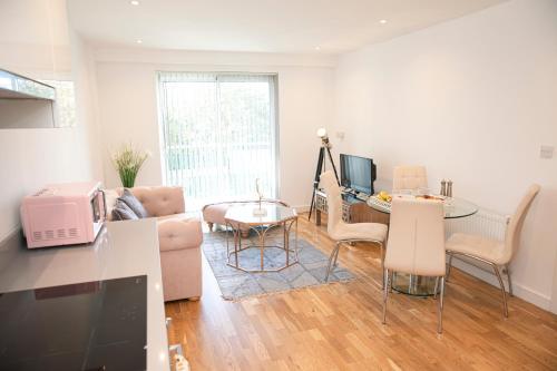 a living room with a couch and a table at Sunshine Place in Enfield