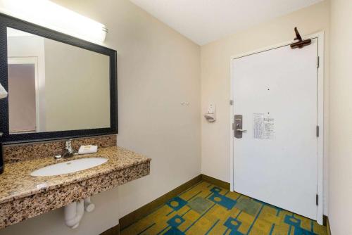 a bathroom with a sink and a mirror at La Quinta by Wyndham Mansfield OH in Mansfield