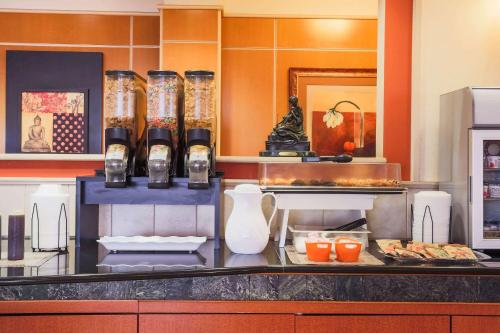 a kitchen with a counter with some food on it at La Quinta by Wyndham Islip - MacArthur Airport in Bohemia