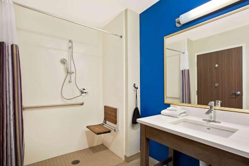 a bathroom with a sink and a shower and a mirror at La Quinta by Wyndham Page at Lake Powell in Page