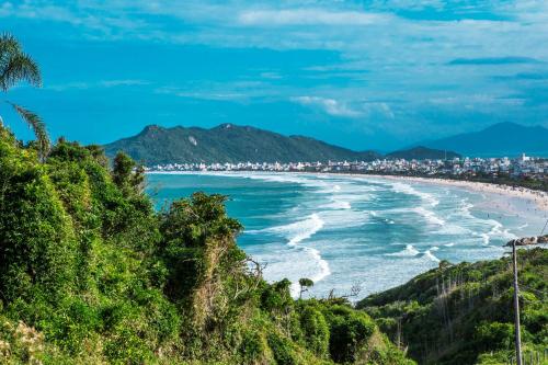 a view of the beach from a hill at Hotel Itapema Meia Praia in Itapema