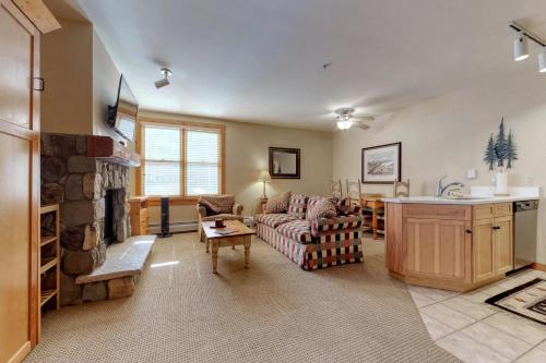 a living room with a couch and a fireplace at Buffalo Lodge in Keystone