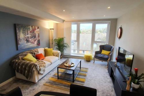 a living room with a couch and a table at The Copper Pan by Ritual Stays in Hemel Hempstead