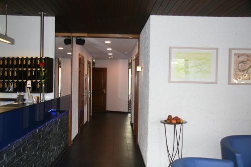 a hallway leading to a wine tasting room with a counter at Hotel Eremitage in Arlesheim