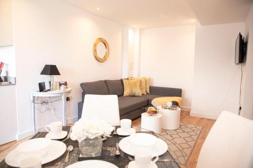 a living room with a couch and a table at Sunshine Place in Enfield