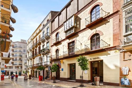 a street in a city with buildings at Apartamentos Casapalma Centro Histórico in Málaga