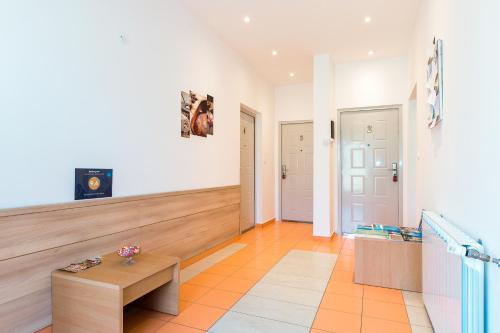 a living room with a bench and a table at Guest house Slatki Snovi in Knin