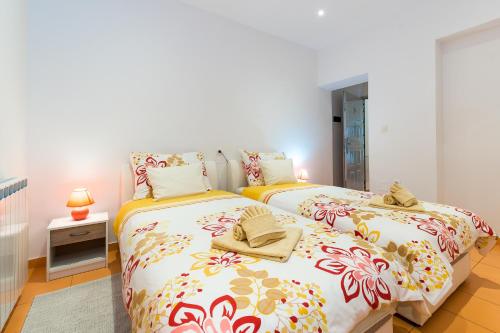 two beds in a small room with white walls at Guest house Slatki Snovi in Knin