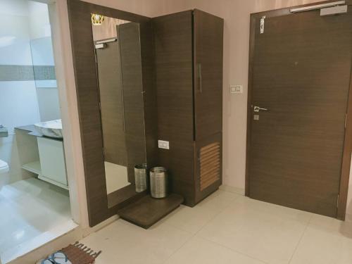 uma casa de banho com um chuveiro e uma porta de vidro em HOTEL AIRPORT INN ONE em Ahmedabad