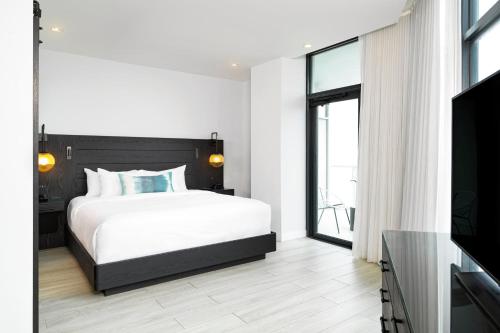 a bedroom with a bed and a large window at Wave Resort in Long Branch