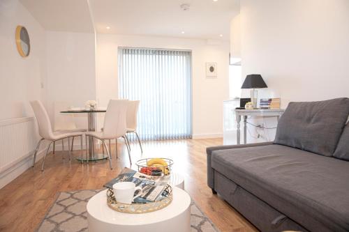 a living room with a couch and a table at Sunshine Place in Enfield