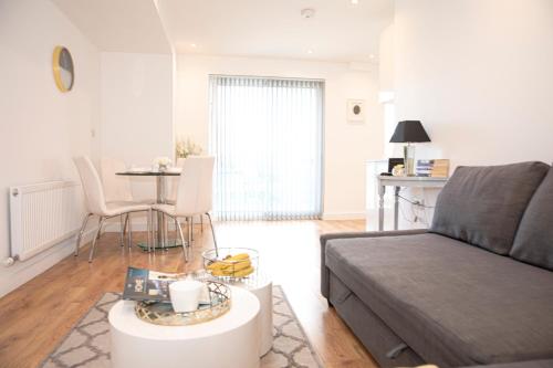 a living room with a couch and a table at Sunshine Place in Enfield