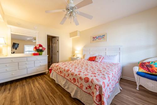 a bedroom with a bed and a ceiling fan at Follow the Sun in Duck