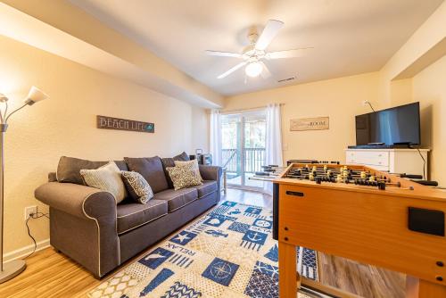 a living room with a couch and a flat screen tv at Follow the Sun in Duck