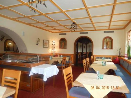 a restaurant with tables and chairs in a room at Hotel Faller in Breitnau