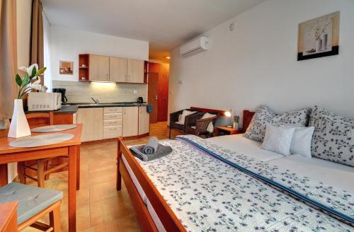 a living room with a couch and a kitchen at Penzion U zámeckého parku in Třeboň