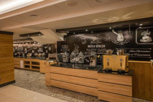 a restaurant with a bar with a black wall at Adresin Hotel in Edirne