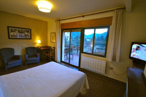 Ένα ή περισσότερα κρεβάτια σε δωμάτιο στο Hotel Els Puis