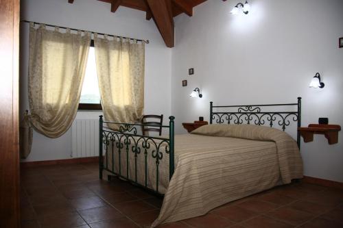 En eller flere senger på et rom på AGRITURISMO Costa Verde