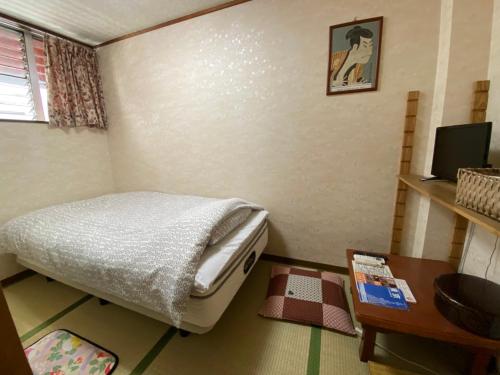 Postel nebo postele na pokoji v ubytování Asakusa Ryokan Toukaisou