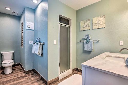 a bathroom with a toilet and a shower and a sink at Steps to Daytona Beach Updated Home with Deck! in Daytona Beach