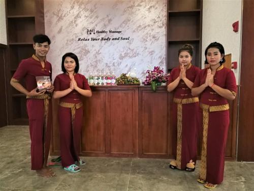 a group of four people standing in a room praying at PACI Hotel&SPA in Sihanoukville