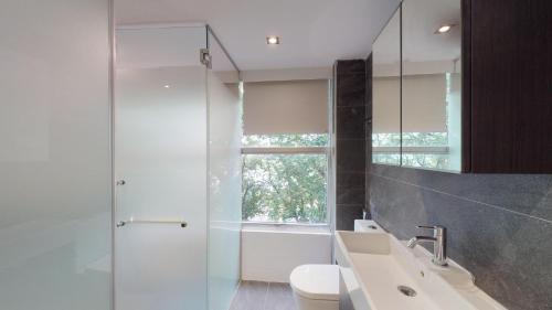 a bathroom with a sink and a toilet and a shower at International Service Apartments at Raeburn Park in Singapore