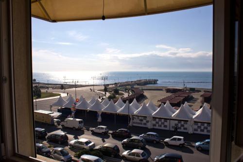 a view from a window of a parking lot with a beach at Hotel La Scaletta in Lido di Ostia