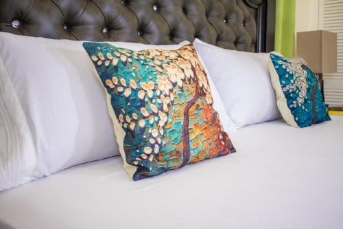 two pillows sitting on top of a bed at Ocho Rios Premier 2 Bedroom Villa at Drax Hall in Mammee Bay