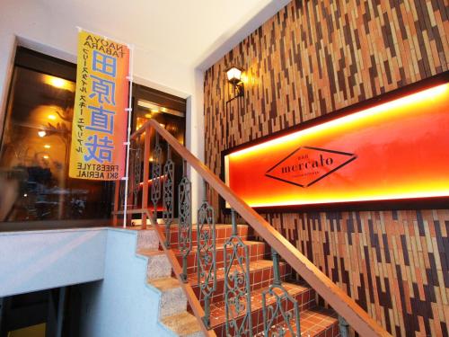 a staircase in a building with a snowboard on the wall at Hotel Grace Hakuba in Hakuba