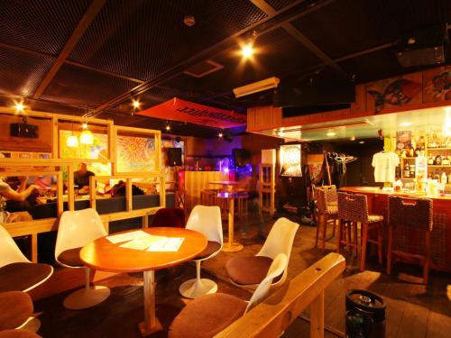 a restaurant with a table and chairs and a bar at Hotel Grace Hakuba in Hakuba