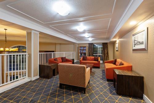 a lobby with couches and chairs on a balcony at Holiday Inn & Suites San Mateo - SFO, an IHG Hotel in San Mateo