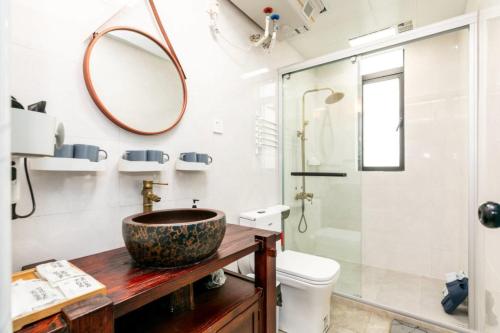 a bathroom with a sink and a toilet and a mirror at CSDY House in Shanghai